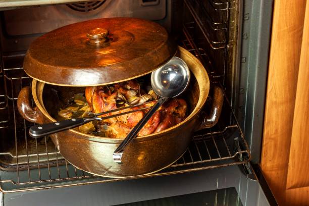 istock Roasted pork knee with leek. Baking meat. Electric domestic oven. Kitchenware. 911481328