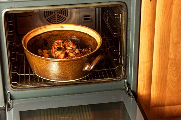 istock Roasted pork knee with leek. Baking meat. Electric domestic oven. Kitchenware. 911483504