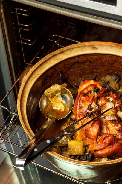 istock Roasted pork knee with leek. Baking meat. Electric domestic oven. Kitchenware. 911483600
