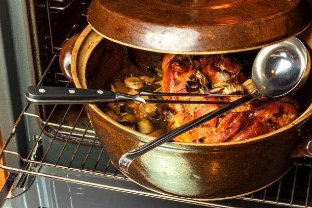 istock Roasted pork knee with leek. Baking meat. Electric domestic oven. Kitchenware. 911483748