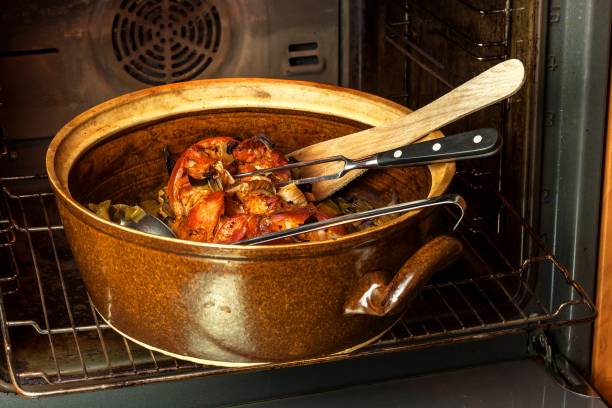 Roasted pork knee with leek. Baking meat. Electric domestic oven. Kitchenware.
