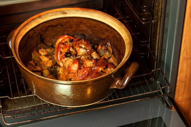 istock Roasted pork knee with leek. Baking meat. Electric domestic oven. Kitchenware. 911483932