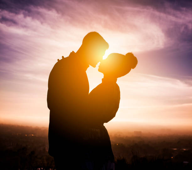 istock Diverse Couple Engagement Silhouettes at Sunset 911487252