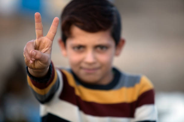 Camping, Tent, Syria, Europe, Greece, little boy showing peace sign, peace, fingers