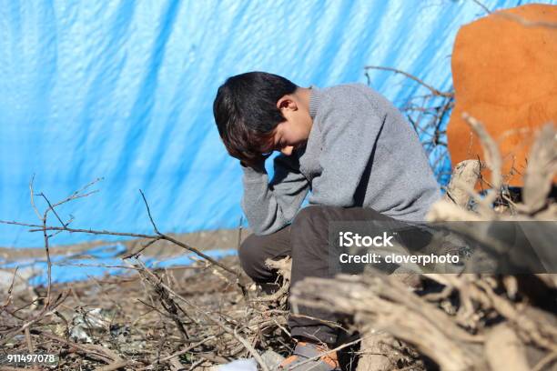 Sad Syrian Little Boy In Refugee Camp Stock Photo - Download Image Now - Child, Refugee, Syria