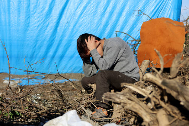 istock sad syrian little boy in refugee camp 911497082