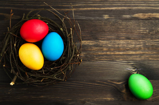 istock Easter eggs on a wooden background .Easter eggs of different colors .Easter eggs top view 911497442