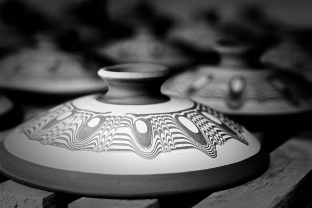 Man forming a clay pot on pottery wheel