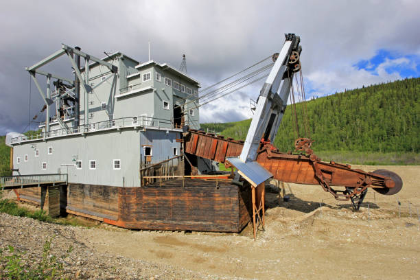 The remains of a historical delelict gold dredge on Bonanza creek near Dawson City, Canada The remains of a historical delelict gold dredge on Bonanza creek near Dawson City, Yukon, Canada alaska gold rush stock pictures, royalty-free photos & images