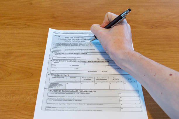 Man hand filling Polish tax form PIT-39.