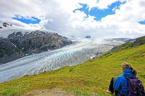 Beautiful woman looking at Exit Glacier, Harding Ice Field, Kenai Fjords National Park, Alaska, USA