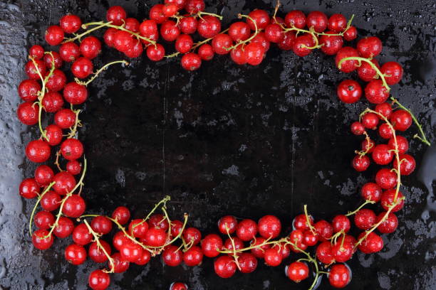 istock Red currant and cherry on a black background, red berries on a metallic retro background, healthy food, vegan, currant berries for cooking, cherry on an old background 911522356