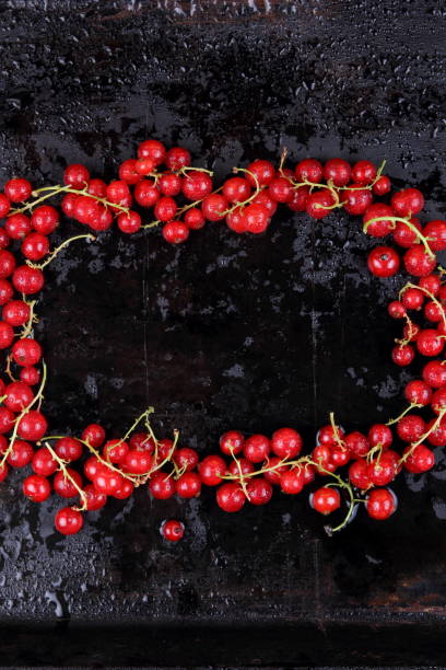 istock Red currant and cherry on a black background, red berries on a metallic retro background, healthy food, vegan, currant berries for cooking, cherry on an old background 911522426