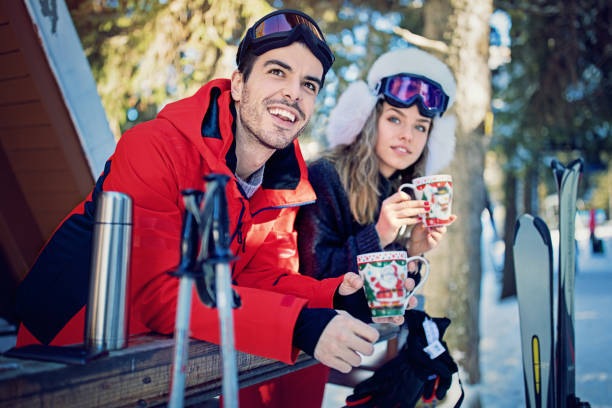 istock Young couple is drinking hot tea after skiing 911527202