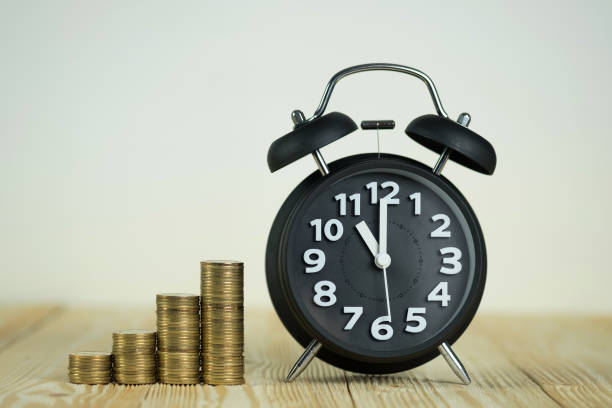 istock Steps of coins stack with vintage alarm clock on wooden working table with copy space for text, financial and business planning concept. 911536140