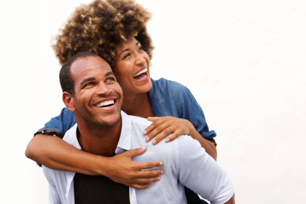 istock smiling couple standing in embrace on white background 911536212