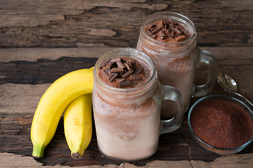 Banana and chocolate, smoothie milk, put glass on wooden floor