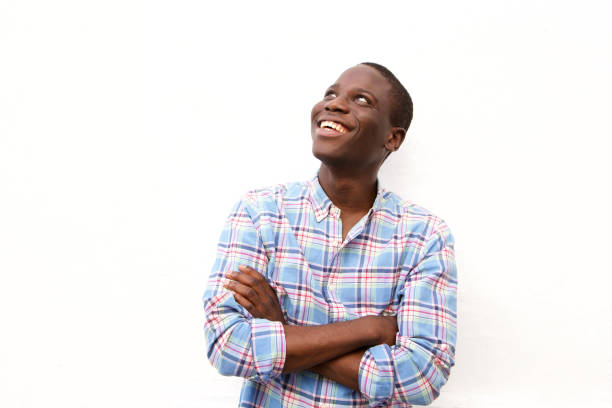 istock Cheerful young black man with arms crossed and looking up 911537246