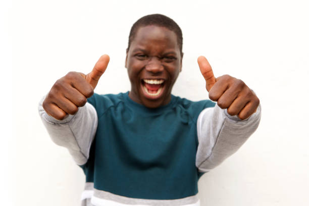 istock Close up excited young man showing thumbs up with two hands on white background 911537282