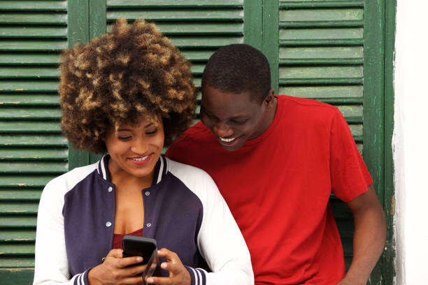 istock happy young couple together with mobile phone 911537326