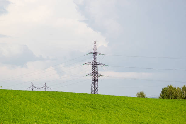 istock Tower of power lines on a green hill 911543828