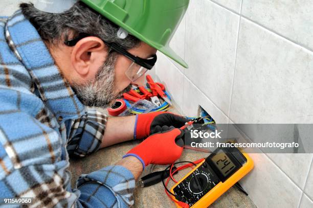 Electrician Technician Working Safely On A Residential Electrical System Stock Photo - Download Image Now