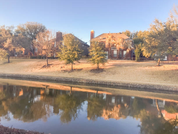 Riverside apartment building complex reflection at sunset Typical riverside apartment building complex reflection at sunset in Irving, Texas, USA, wintertime. desoto tx stock pictures, royalty-free photos & images