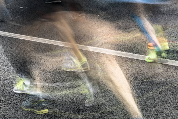 istock People running in marathon on city streets. Motion blur. 911549496