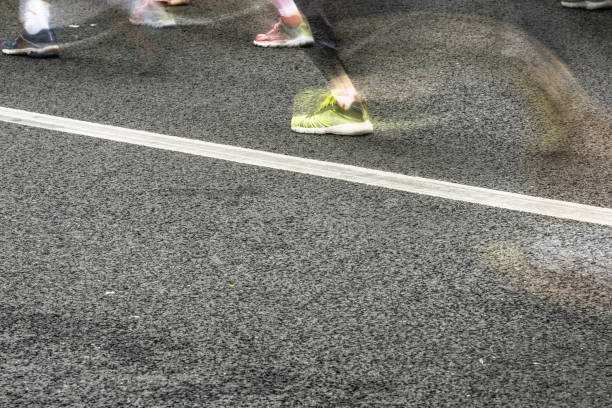 istock People running in marathon on city streets. Motion blur. 911549498