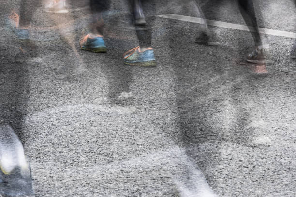 istock People running in marathon on city streets. Motion blur. 911549610