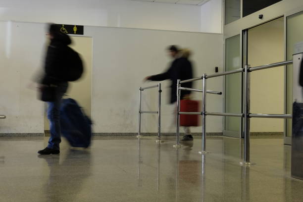 istock blurry people walking in the  airport 911549670
