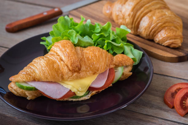 istock Croissant with ham, cheese and vegetable on plate 911552770