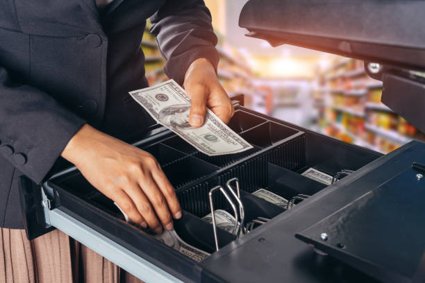 female hand with money in supermarket shop. american dollar. us dollar. cash on cashier's desk. hand giving cash. payday paying cashier access. - cash register register wealth checkout counter imagens e fotografias de stock