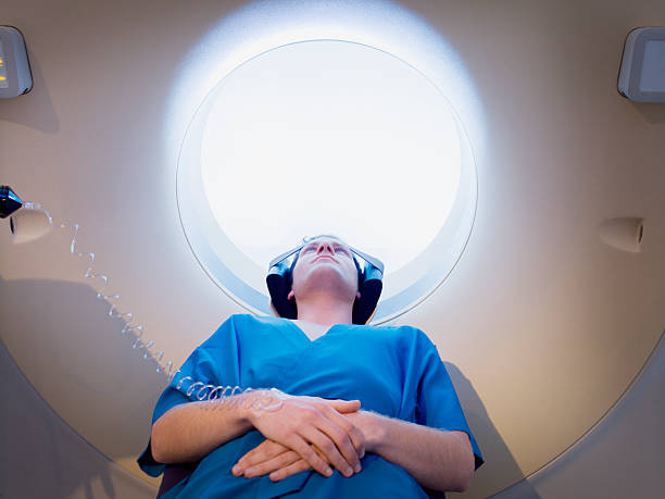 Patient about to have MRI examination  mri scanner stock pictures, royalty-free photos & images