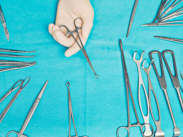 Doctor holding clamp  forceps stock pictures, royalty-free photos & images