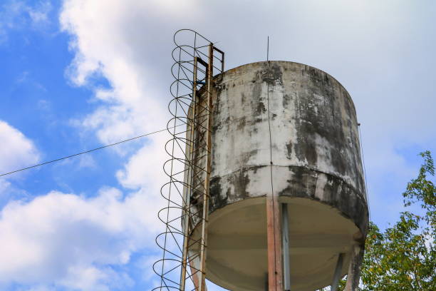 Bangkok, Thailand - 09 Feb, 2023 - An old water tower made of cement and metal spiral staircase is an elevated structure supporting a water tank constructed by The influence European architecture and considered one of the historic building in Bangkok, Large water tank in the water supply system. Selective focus.