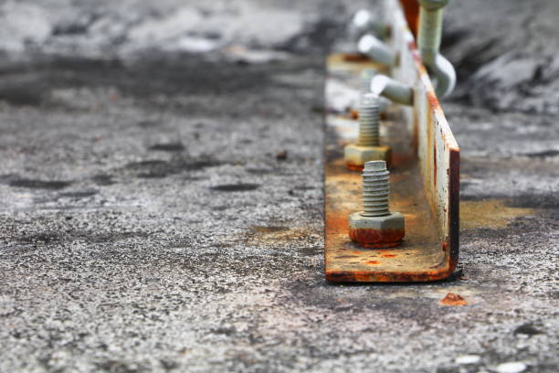 istock screw nut rusted sticking iron plate on  concrete floor  select focus with shallow depth of field. 911569970