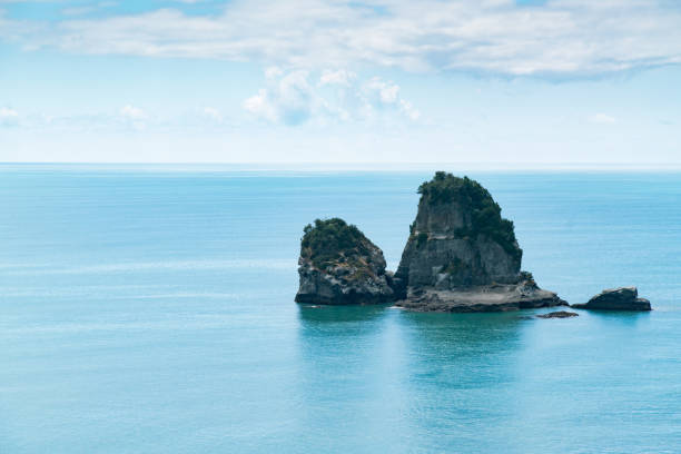istock Small rock island on seacoast skyline 911570176
