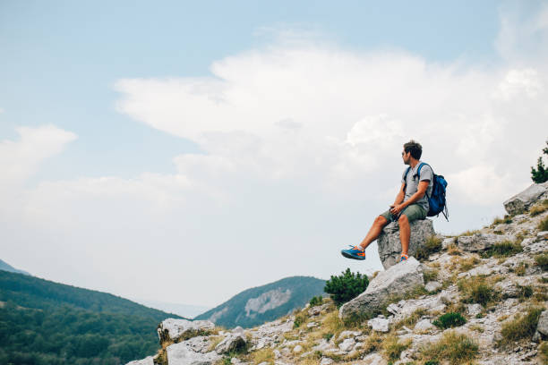 istock Young man enjoying a beautiful view in the nature 911573794
