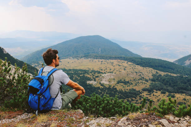 istock Young man enjoying a beautiful view in the nature 911573814