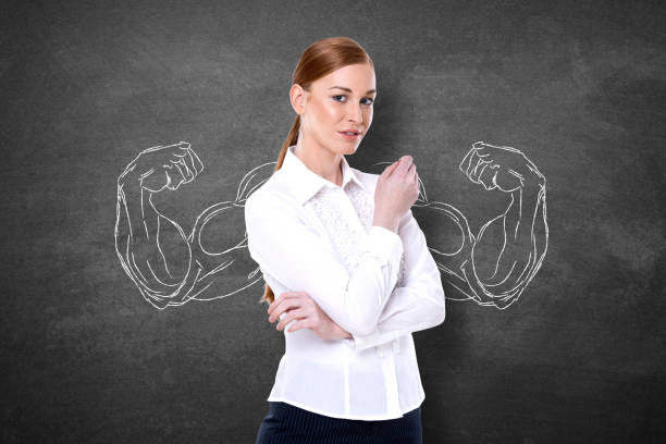 strong businesswoman with drawing of flexing muscles - muscular build bicep women female imagens e fotografias de stock