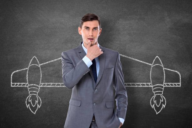 istock Businessman with drawn aircraft wings 911578860