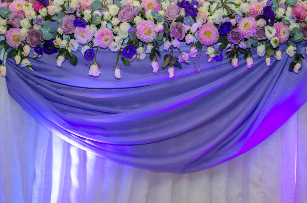 istock Wedding decoration with fresh flowers decorated with a purple cloth 911579108