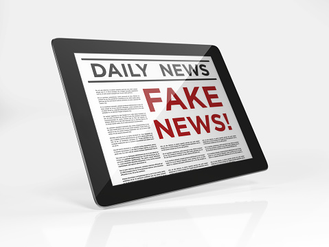 Fake news headline on a digital tablet. Horizontal composition with copy space. Clipping path is included.