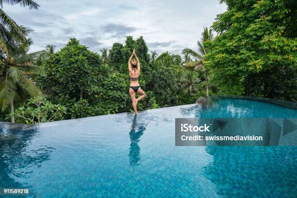 Young Woman Standing On The Edge Of An Infinity Pool Ubud Bali Stock Photo - Download Image Now