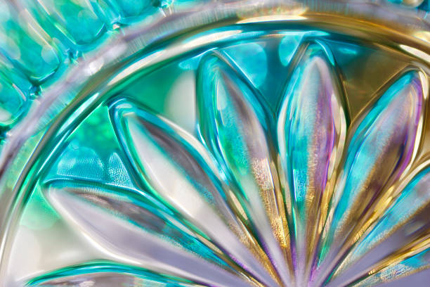 Vibrant color macro abstract of beautiful lead crystal glass designs with bokeh This image shows an extreme close up view of stunning designs in lead crystal glass with bokeh, reflecting bright colors in natural sunlight. lead cut glass crystal stemware stock pictures, royalty-free photos & images