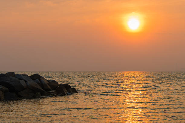 istock Sunrise in the sea with soft wave and cloudy. 911590606