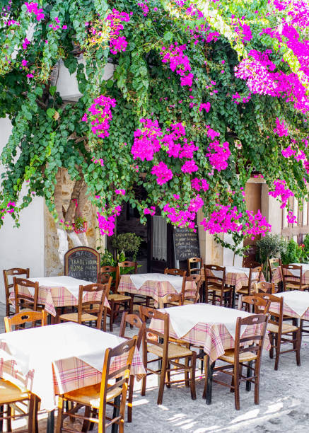 PANORMOS, CRETE - SEPTEMBER 15:  Bougainvillea flower and empty taverna at resort Panormos on September 15, 2017 in Panormos