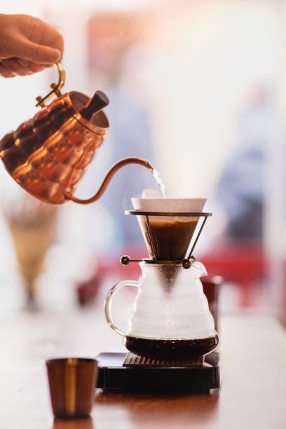 istock Drip coffee, barista pouring water on coffee ground with filter 911600000