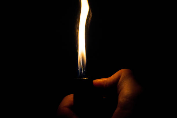 istock Close up view of real sparking light from lighter in dark black background 911611616